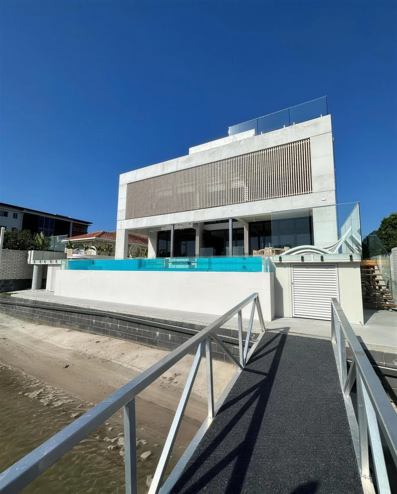 Rendered waterfront home with a pool and jetty