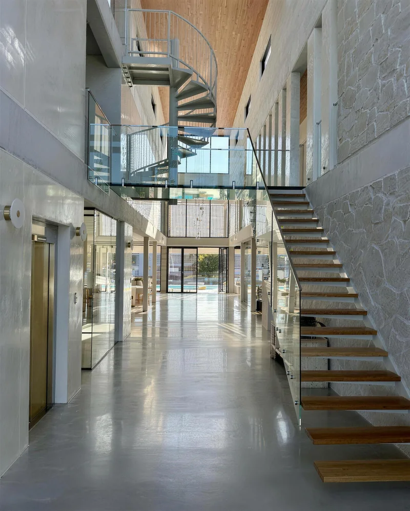 Interior with a white spiral staircase and polished plaster walls